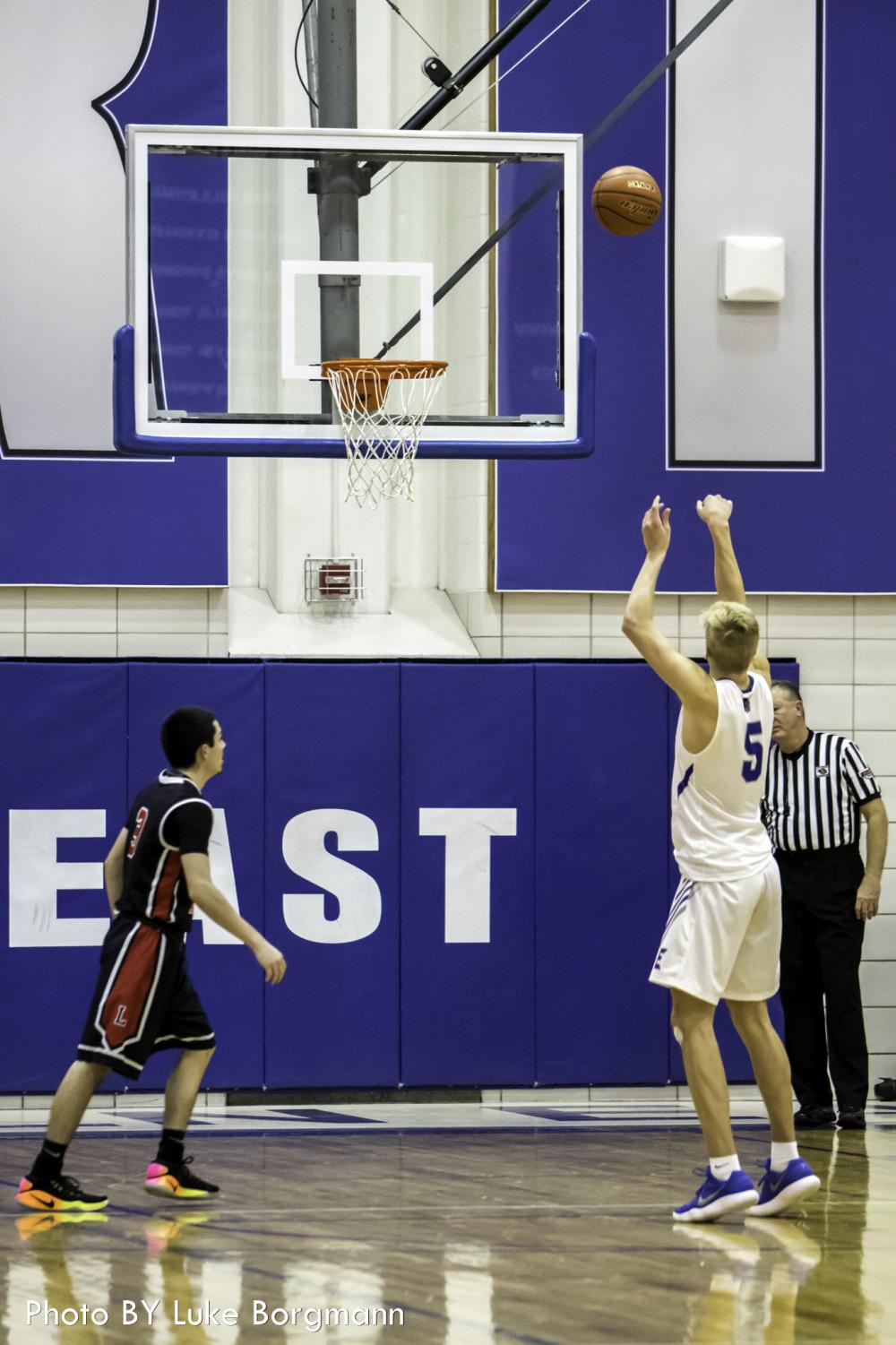 Lincoln East senior forward Sam Griesel (5) shoots a free throw against Lincoln High in the HAC tournament on December 29 at Lincoln East High School.