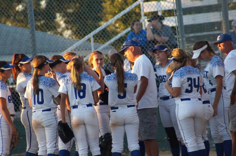 Lincoln East head softball coach Lance Kingery addresses his team between a double header in Lincoln on Tuesday, August 22. East swept Fremont to improve to 4-1 on the season.