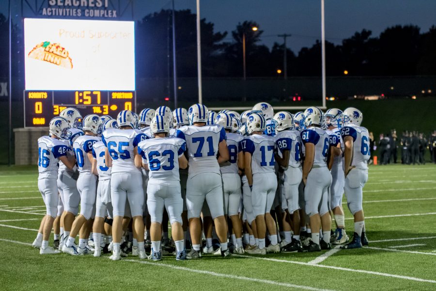 The Lincoln East varstiy football teams huddles on the field before their game against Lincoln Southeast at Seacrest Field on Friday September 8th. The Spartans lost with a final score of 6-26, dropping them to 1-2 on the season. 
Photo By Luke Borgmann
