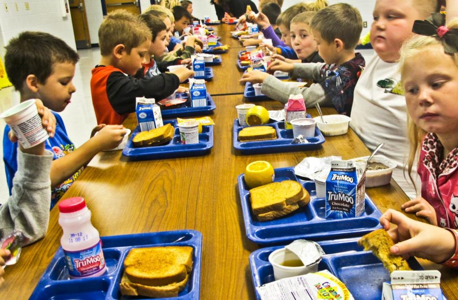 First grade students at Orange Elementary in Lincoln, Nebraska eat a lunch with fruit or cereal, grilled cheese, and milk. This is just one of the basic lunches that are causing more students to eat at home or bring their lunch.