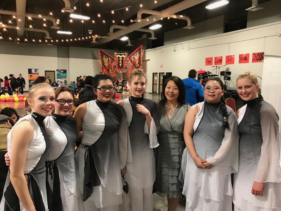 The Lincoln East Lunar Lotuses pose with the ACCC Cultural Program Coordinator, Rebecca Reinhardt, for a picture after their performance at the Lincoln Room of the Lancaster Event Center on Sunday, Feb. 25, 2018. Left to Right: Elise Benson (9), Angelina Nahorny (11), Angel Trinh (12), Beth Nipper (10), Rebecca Reinhardt, Yiling Zuo (10), and Ava Winjum(10). [Member Chloe Weakly (10) is not pictured]. Photo Courtesy of Rebecca Reinhardt.