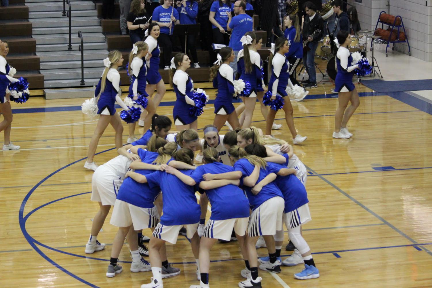 The Lincoln East Girls Varsity basketball team huddle together at the start of the Omaha Burke game on Friday, February 2, at East High School.