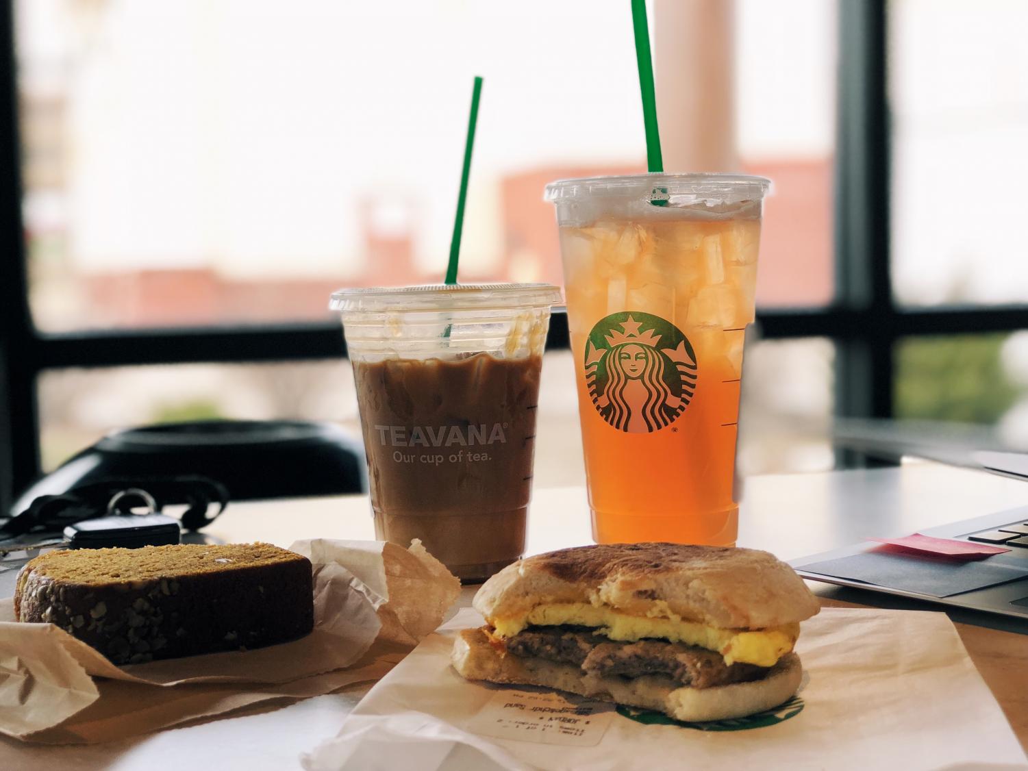 This delicious Starbucks spread features an iced coffee, iced tea, a pumpkin loaf and a sausage breakfast sandwich.