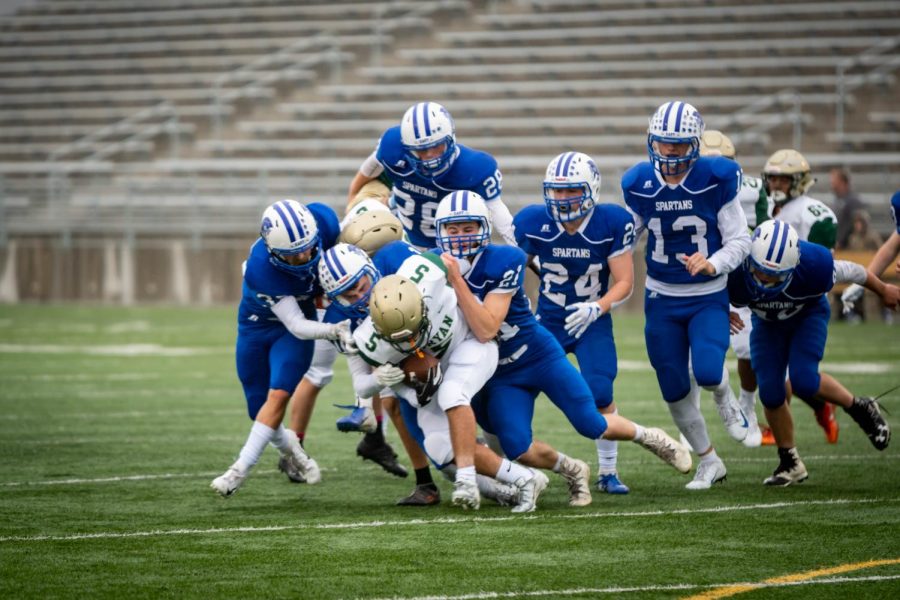 The Spartan defense swarms an Omaha Bryan ball carrier on Friday afternoons game.