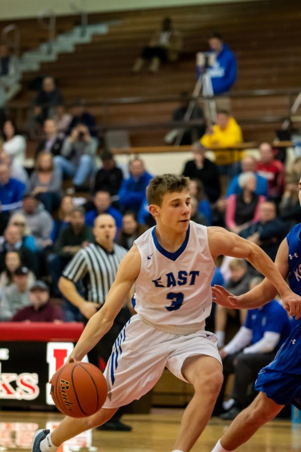 East sophomore point guard Carter Glenn attempts to drive the lane in the HAC Tournament against Kearney.