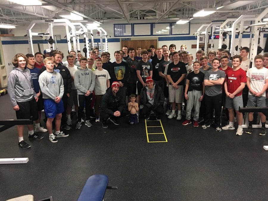The 2019 baseball team gathers for a photo after a workout.