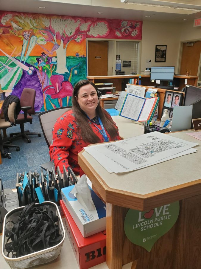 Ms. Manzitto working at her desk in the East main office.