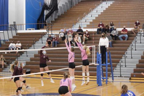 Brooklyn Fuchs and Annalee Ventling-Brown look to block a hit from Norfolk.