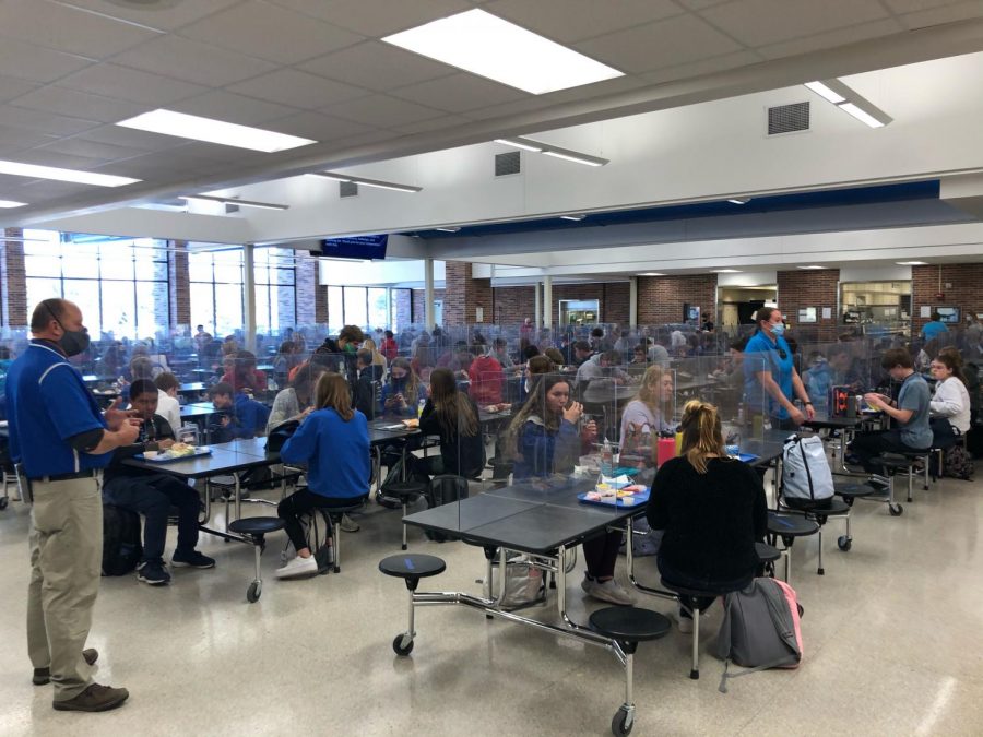 East High School students eating between dividers in the school cafeteria. These dividers have been mandated by LPS to block the spread of COVID 19.