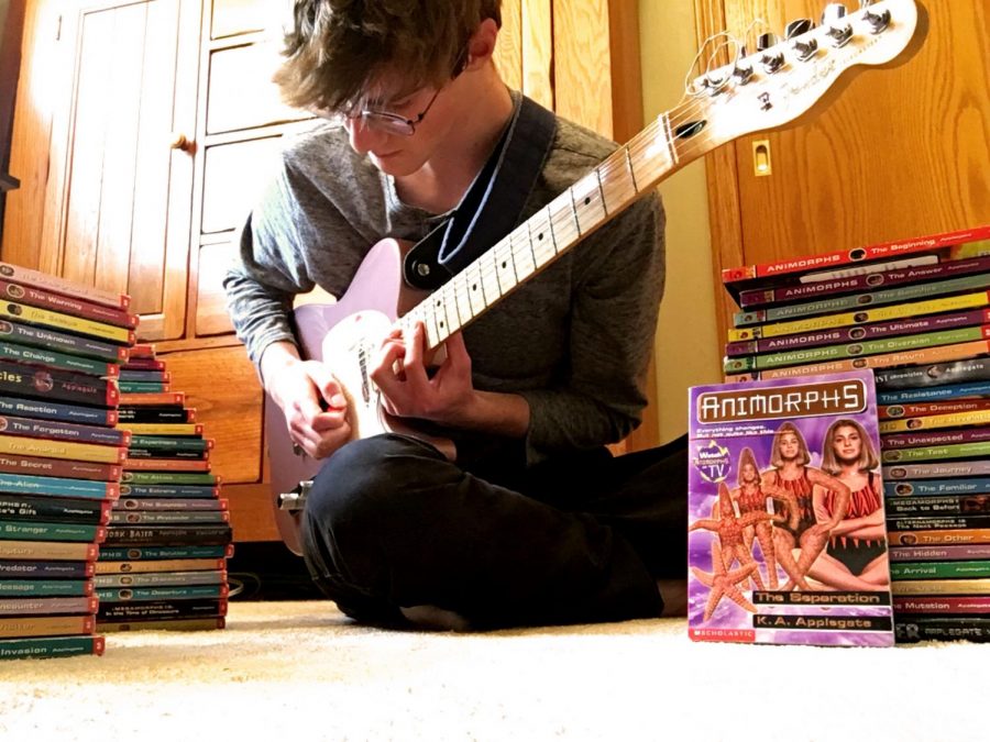 Peter Schmit with his guitar & his proud collection of all the Animorphs books.