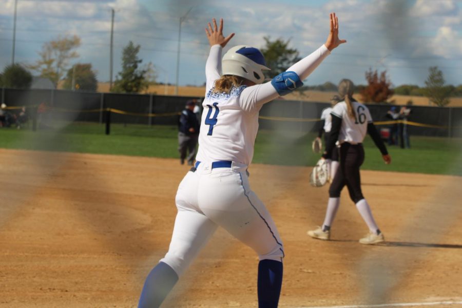 Senior Morgan Adams throws her arms up in celebration of her 23rd home run and becoming the new record holder for home runs in one season. Adams set the record in the state championship game on October 15th, 2021 where the Spartans collected second place.
