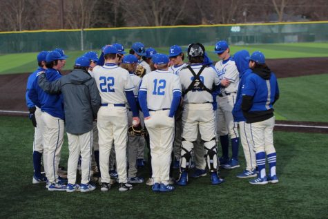 The Lincoln East Varsity Baseball team huddles together on Opening day March 18th, 2022