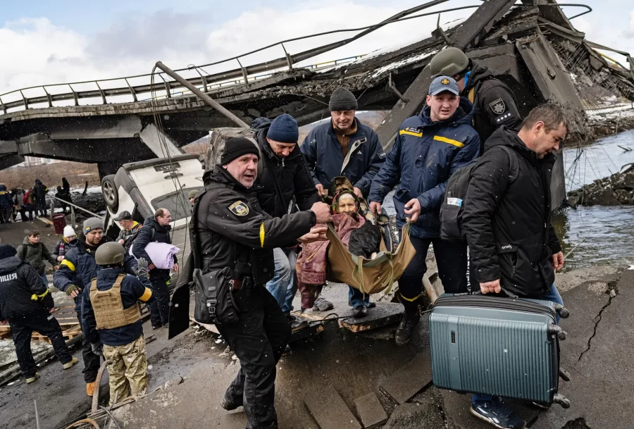Civilians evacuated across the remnants of a destroyed bridge in Irpin, a northwest suburb of Kyiv, Ukraine, this month.
