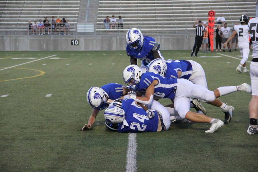 The Lincoln East Spartans defense tackle a Northeast Rockets player on September 15, 2022.