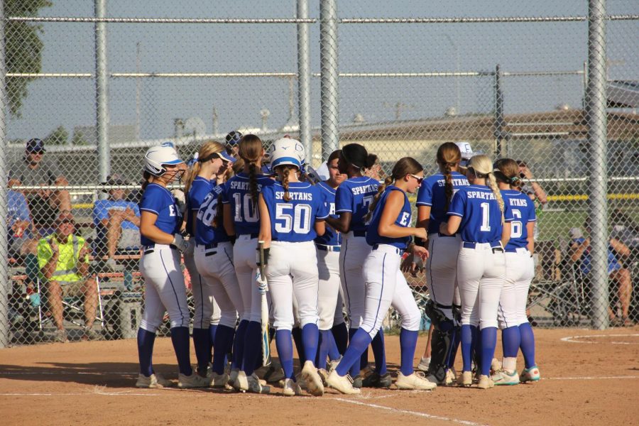 The Lincoln East varsity softball team gather around the plate after a home run against Kearney on September 6th, 2022.