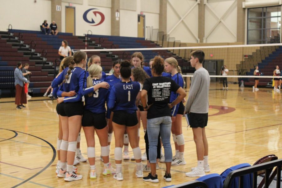 The Spartan Volleyball team listens to Coach Johnson during a timeout at Lincoln Northstar on September 6, 2022. The players were practicing their theme of building more together.
