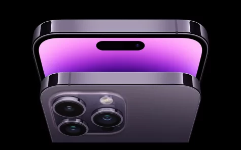 The iPhone 14 in the color of deep purple. At the top of the screen is a new feature called a Dynamic Island that interacts with your alerts and notifications.