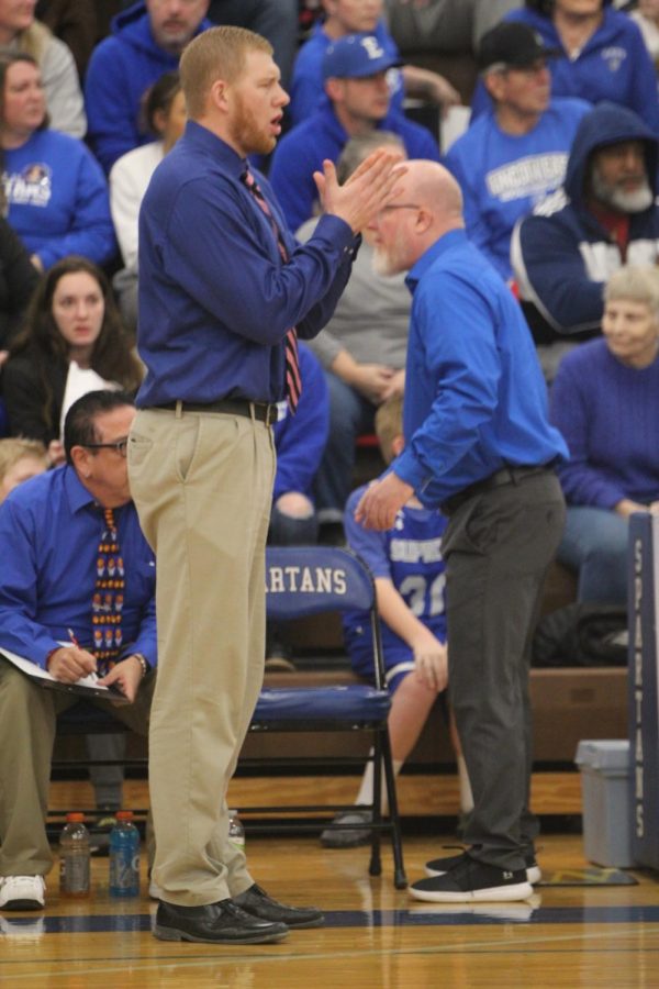 Alex McCleary encourages his team at the district final on Friday February 24th, 2023. McCleary wrapped up his first year as varsity head coach with a record of 17-4.