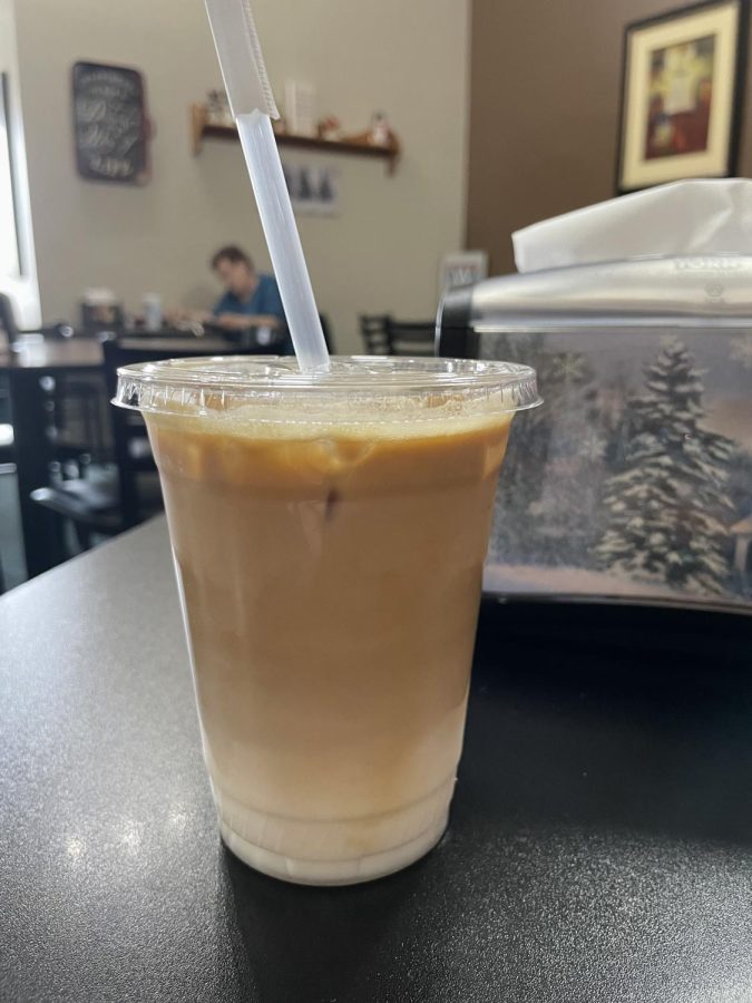 Iced caramel latte pictured at Mocha Cs in Wahoo, NE. This cafe was filled with small town energy and had a very comfortable setting.