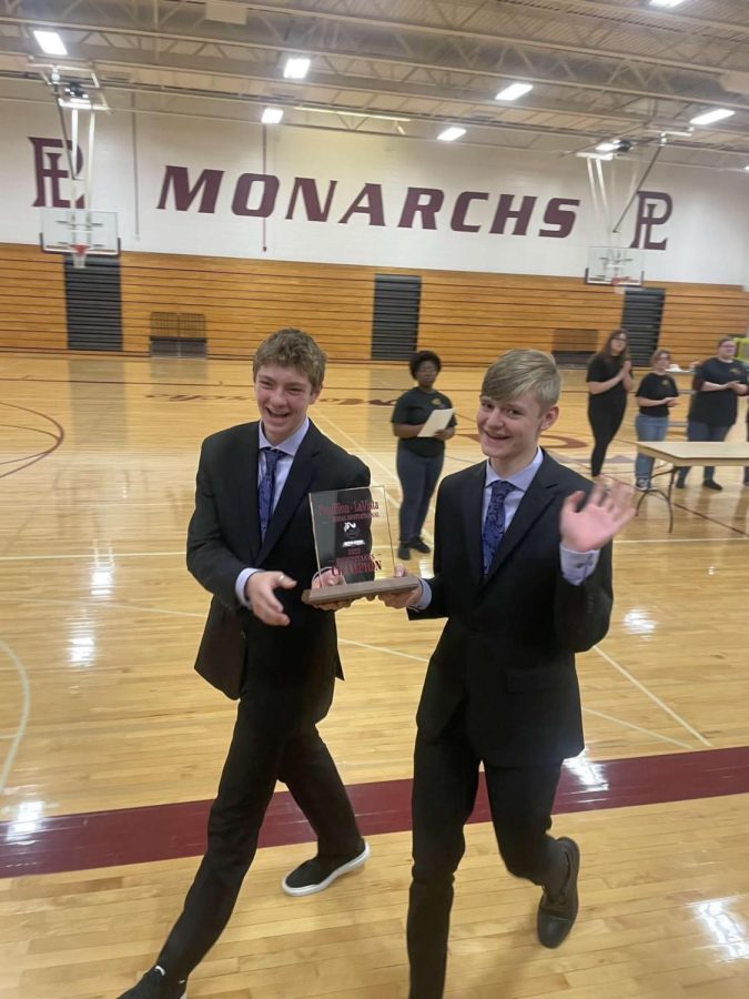 Max Apel (left) and Jack Welstad (right) carry the team trophy at Papillion La Vista South high school on November 12, 2022. Spartan Speech has won nine meets so far with the latest being the Lincoln Southwest Silver Talon on Saturday January 19, 2023. 