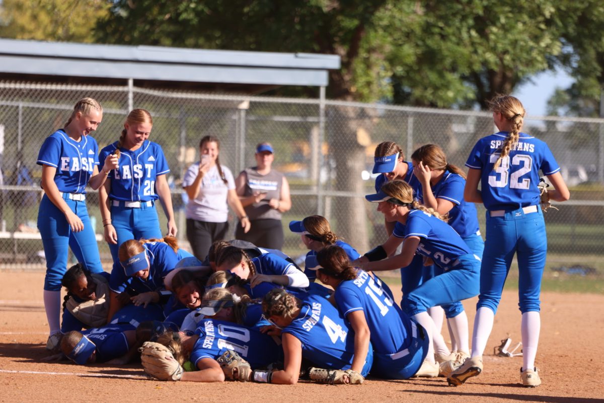 The Lincoln East softball team celebrates winning districts on October 5, 2023. They beat Elkhorn South 7-2, with 5 home runs leading them to victory.