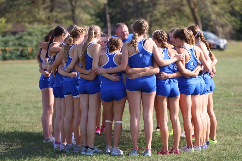 The Lincoln East girls support each other before running their race at the LPS Championships on Friday, September 30, 2023. The girls team won the meet with a score of 23 points overall.