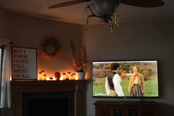 Little Women (2019) plays on a living room T.V. on a cozy autumn afternoon. The film is partially set in fall, and is known for being a go-to comfort movie.