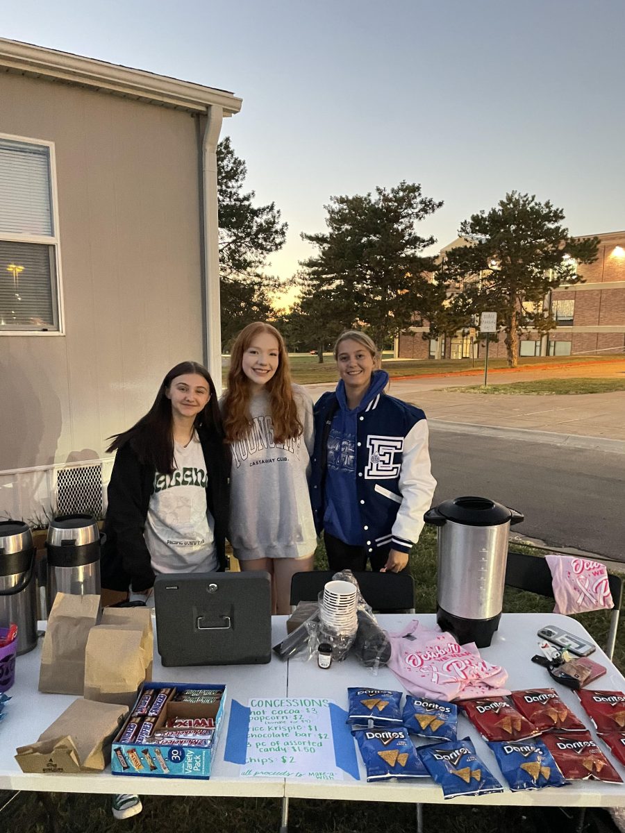 (R-L) Student council members Grace Nieman, Ava Fruhling, and Campbell Cullan run concessions during the Halloween movie night on Thursday, October 19. All of the proceeds from ticket sales, snacks, and hot chocolate went to Make-A-Wish Nebraska.