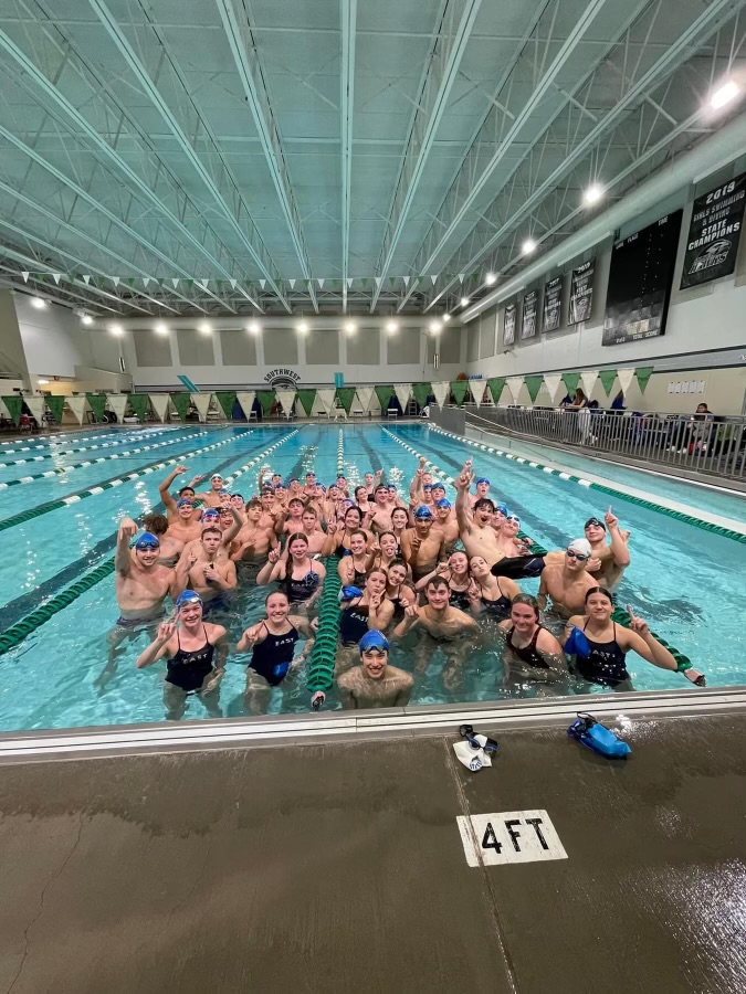 Lincoln East swim team celebrates their win against Lincoln Southwest High School on November 30, 2023. The Spartan boys defeated the Silverhawks 117-70 in the rival match up.