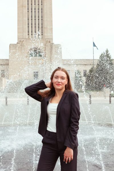 Cassidy Bell, senior, poses in front of the Nebraska State Capitol. Bell has always taken pride in using her voice when it comes to things she is passionate in, like period poverty.
