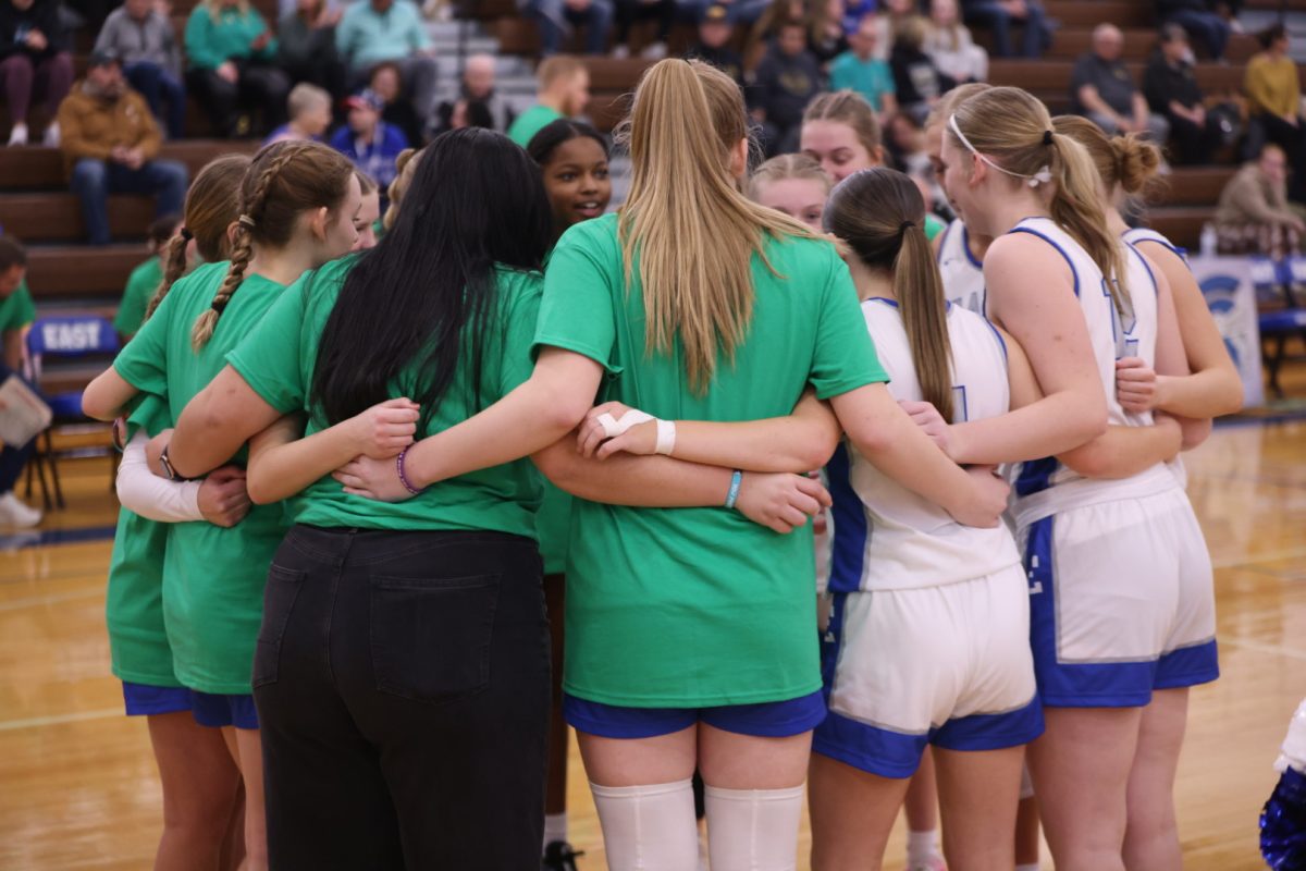 The Lincoln East girls basketball team huddles up right before tip off on January 23, 2024 vs. Lincoln Southeast. The Spartans ultimately lost 50-39.