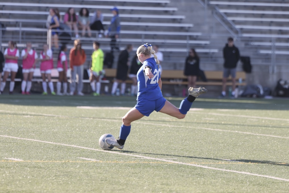 Junior captain MaKynlie Cade kicks the ball in city rivalry matchup vs. the Knights on Tuesday, April 9, 2024, at 5pm at Seacrest Field. Cade led the Spartans to victory scoring one goal.