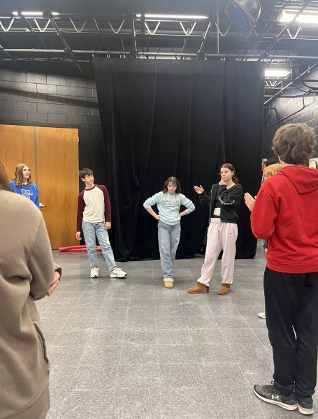 Ash Nabb (black jacket) begins A Wrinkle in Time rehearsal on Monday, April 8, in Easts black box. The cast and crew have worked hard on the show since February.