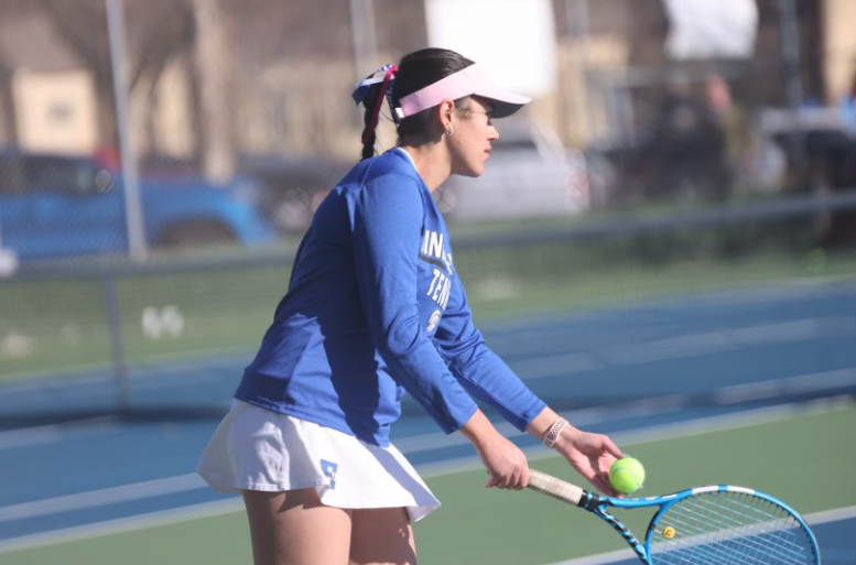 The Spartan girls defeat the Marian Crusaders in a tennis duel at Woods Tennis Center on Wednesday, April 3. Isabella Razdan, as pictured in the photo, gets ready to serve during her doubles match.