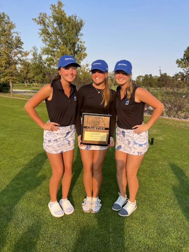 Varsity seniors Kellie Peitzmeier (left), Isabella Elgert (middle), and Addison Shirk (right) holding the districts plaque. The district win on October 7th gave the team confidence to perform well at state on October 14th and 15th.  