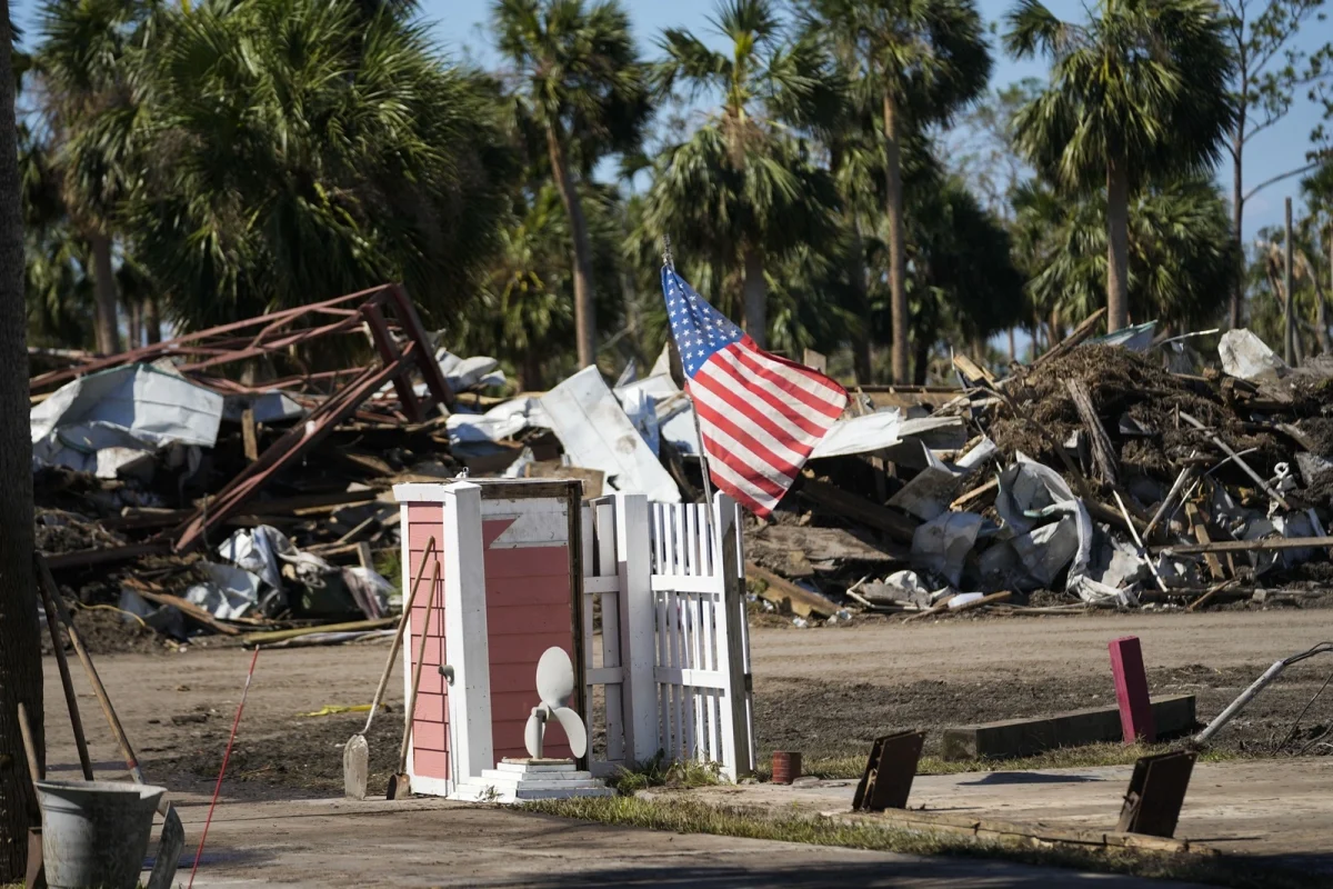 An American flag flies amid destruction in the aftermath of Hurricane Helene, in Jena, Florida. Hurricane Helene, a category 4 tropical storm, caused severe damage to multiple southeastern states at the end of September.