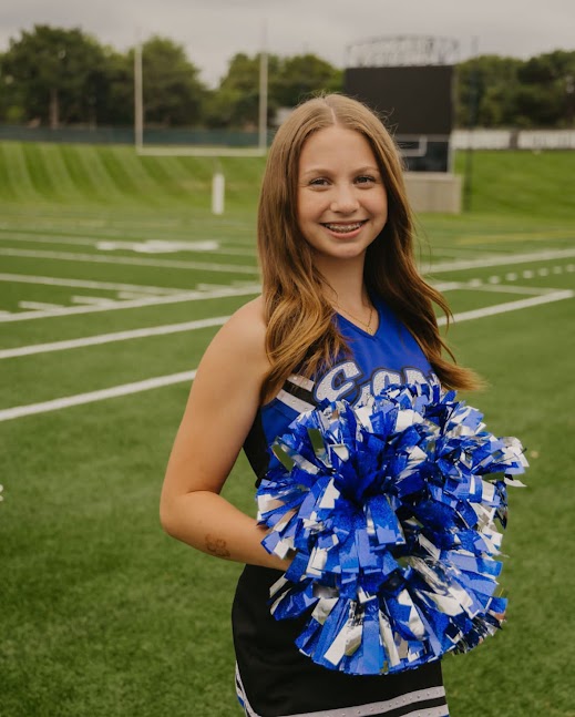 Laila Cardenas strikes a pose on the football field before a game.