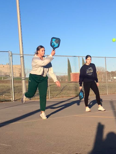 Members of the pickle ball club return the ball to their opponents at the club on November 12, 2024. The nice November weather allows the members of the club to get some fresh air and be outside, instead of in the gyms. 