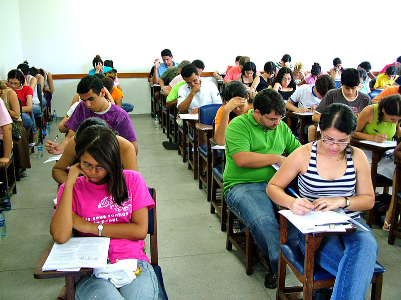 On a given day in May, AP exams will be held at the student's high school. Students taking an exam are put into a room, given the proper materials and a certain amount of time to complete the exam. 