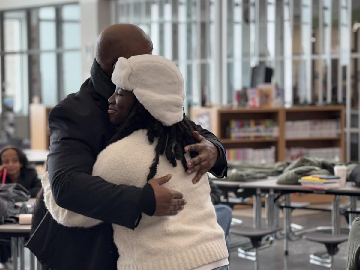 Lincoln East senior Abena Bonsu hugs 93.7 The Ticket FM owner and keynote speaker Derrick Pearson as part of his effort to leave the room covered in love. Pearson has never failed in making strangers feel like family.