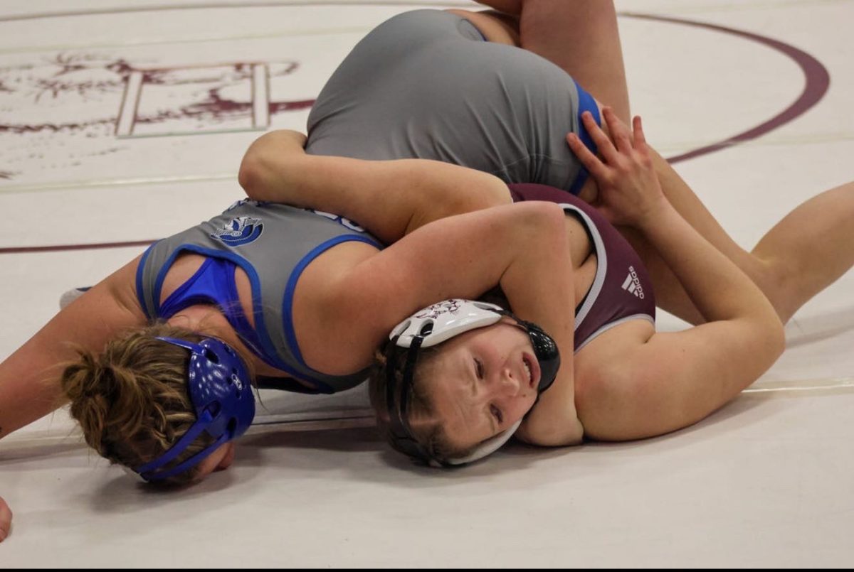 Senior wrestler Carson Shank pinning her opponent during the state tournament. Shank came in third place in her weight class, and helped her team win third place in the tournament.