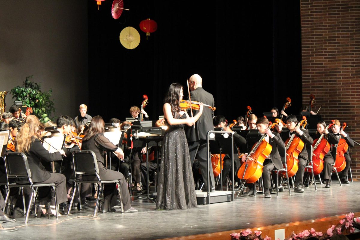 Senior soloist, Sarah Cai preforms at the 2025 Cadenza Concert on the violin. This year's annual Cadenza concert theme was Echoes of Asia.