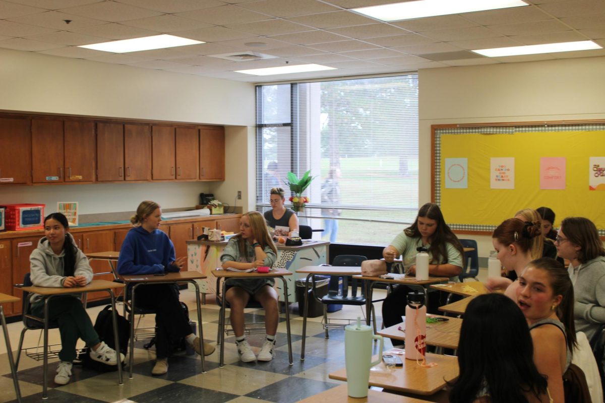 Members of the Girl Up Club discuss the roles of women in media at Lincoln East High School on Thursday, September 18, 2025. The club was looking through different quotes from some favorite fictional characters and depicting what each quote represents about who the women was.