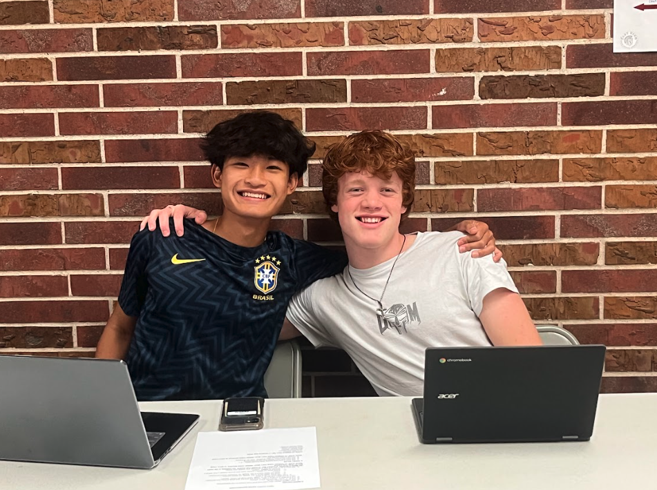 Joshua Ng (10) and Wade Combs (10) taking a quick break from selling tickets at fourth lunch on October 6, 2025. Ng and Combs volunteered on behalf of the East Debate and Speech teams, respectively.