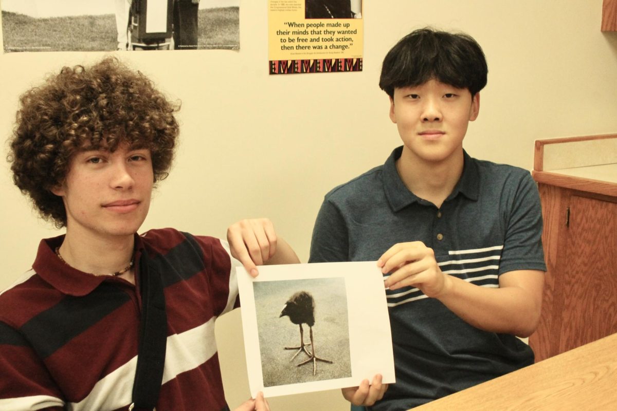 Mark Pirvu (left) and Eje Kim (right) showcase their favorite bird. Pirvu voted the animal photographed for Bird Club's "Bird of the month" competition.