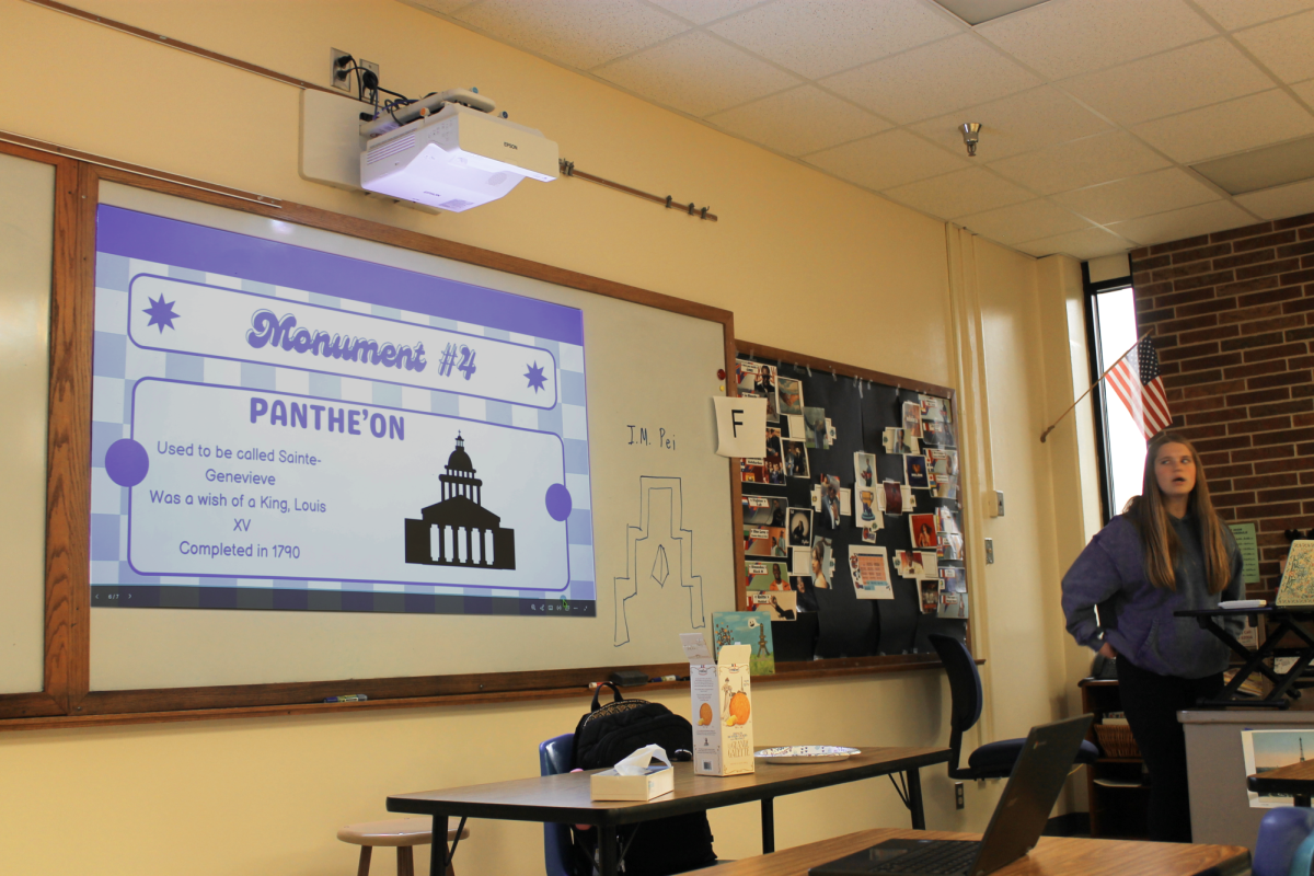Kenzie Dittmer gives a presentation on monuments of France at a French Club meeting. Although Dittmer led the talk, all of the club members participated and shared factoids and anecdotes about the various landmarks.